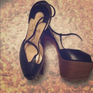 Black with wooden heal. Red Bottoms